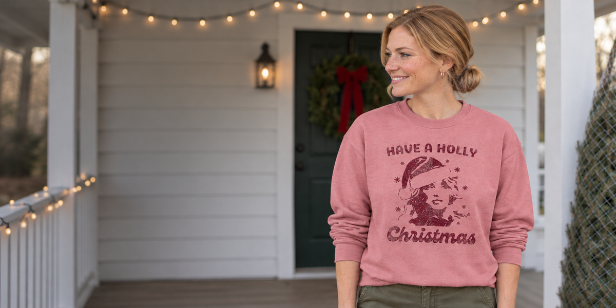 Woman smiling in a grey Be Kind sweatshirt
