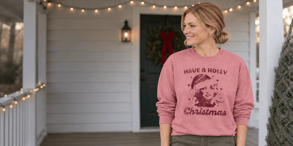 Woman smiling in a grey Be Kind sweatshirt