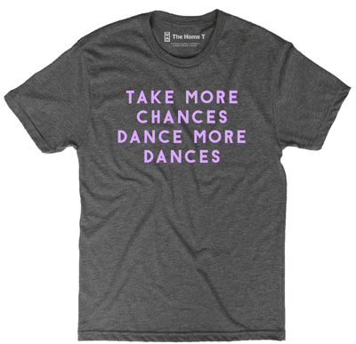 National park t-shirts by TheHomeT with "Take More Chances, Dance More Dances" text in purple print on grey fabric.