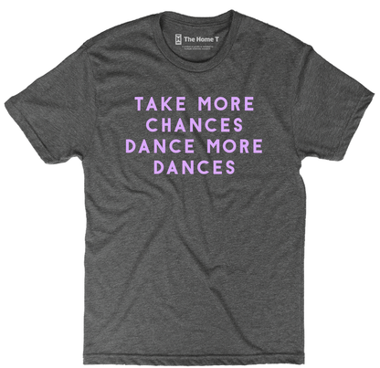 National park t-shirts by TheHomeT with "Take More Chances, Dance More Dances" text in purple print on grey fabric.